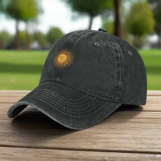 Black baseball cap with a yellow sun emblem on a white background
